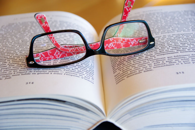 image of reading glasses on an open book